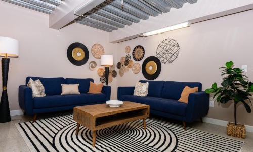 a living room with blue couches