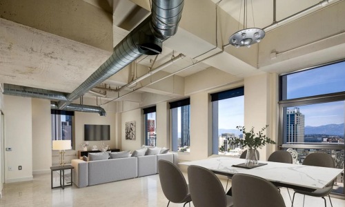 a room with a couch and chairs