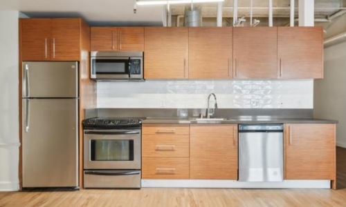 a kitchen with wooden cabinets